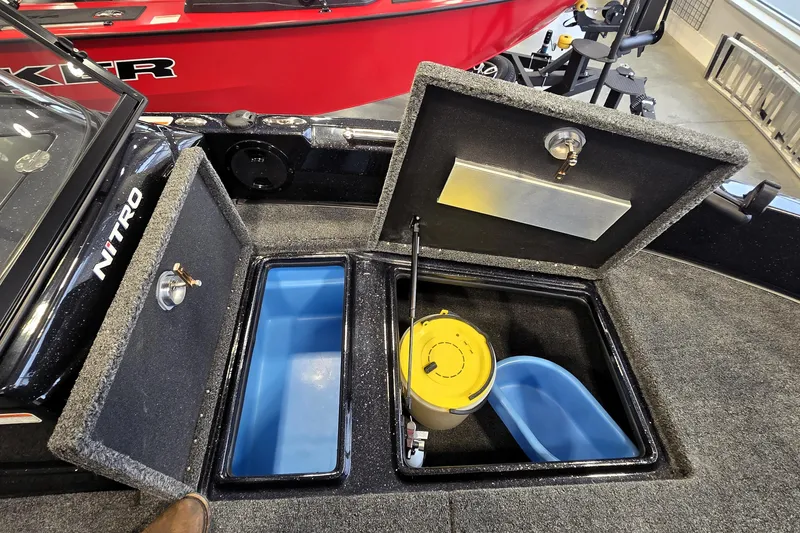 Slide: The Image of 2026 Nitro ZV19 Sport Pro boat storage compartments with open lids and interior view. - 72
