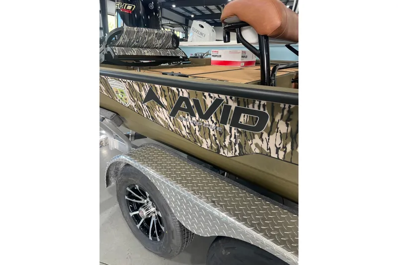 Slide: The Image of 2026 Avid 20 ROGUE CC boat with camouflage design on a trailer. - 10