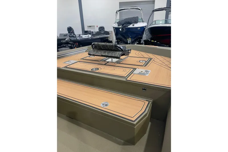 Slide: The Image of 2026 Avid 20 ROGUE CC boat interior with sleek deck design in showroom. - 12