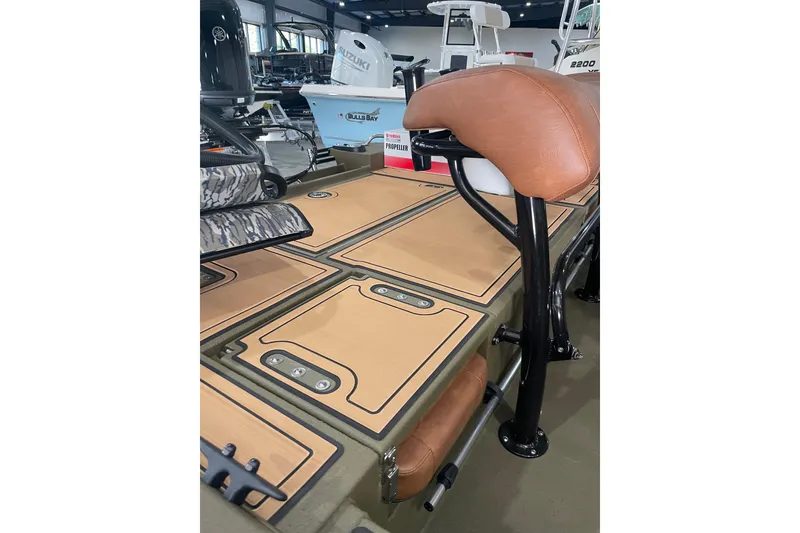 Slide: The Image of 2026 Avid 20 ROGUE CC boat interior with tan seating and deck details. - 13