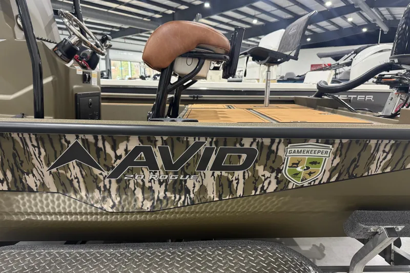 Slide: The Image of 2026 Avid 20 Rogue CC boat with camouflage design and Gamekeeper logo in showroom. - 18