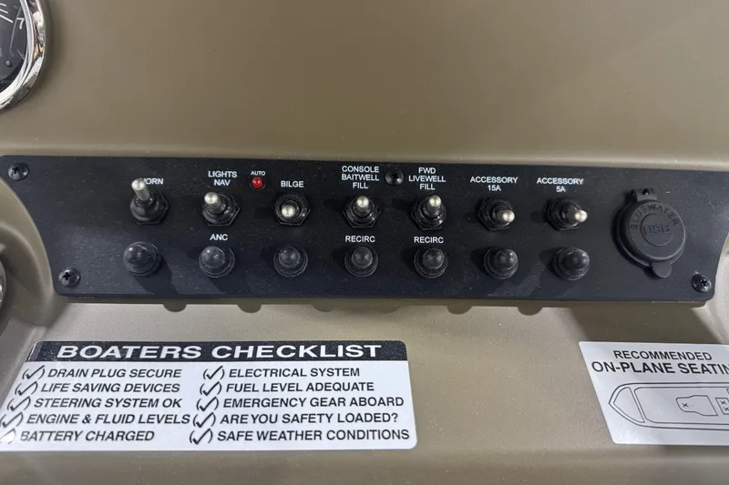 Slide: The Image of Control panel of Avid 20 Rogue CC 2026 boat with switches and boater's checklist. - 22