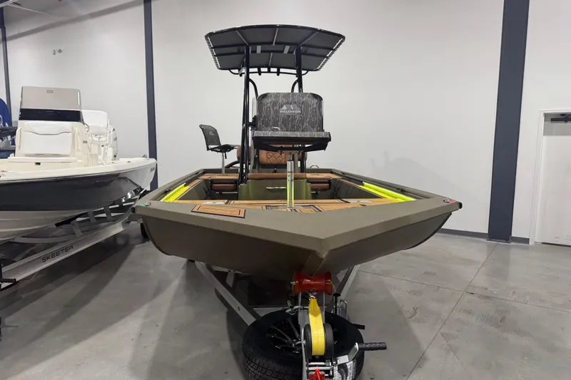 Slide: The Image of 2026 Avid 20 Rogue CC boat in showroom, featuring sleek design and modern amenities. - 29