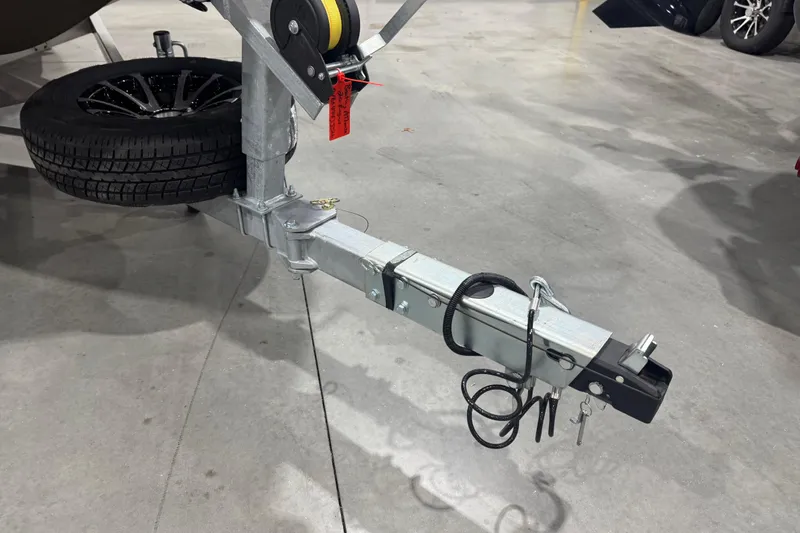 Slide: The Image of Trailer hitch and wheel of 2026 Avid 20 Rogue CC on concrete floor. - 31