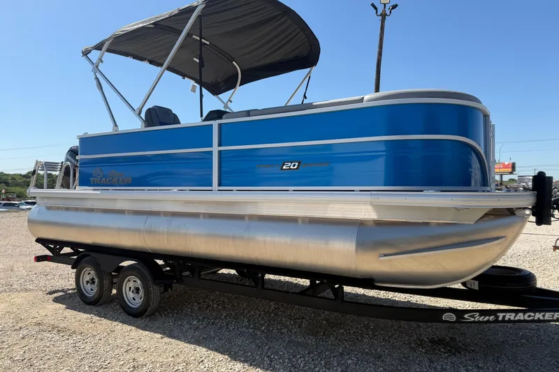 The Image of 2026 Sun Tracker Party Barge 20 DLX pontoon boat on trailer, blue exterior. - 0