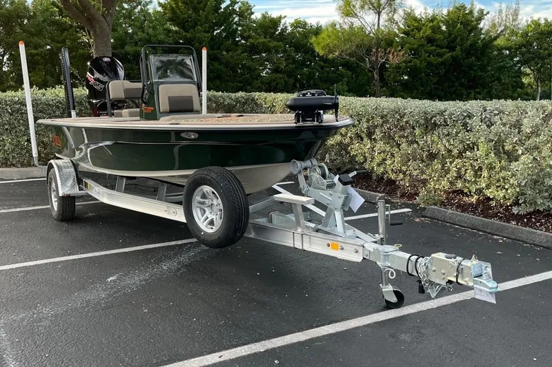 Slide: The Image of 2026 Mako 18 Pro Skiff Backwater Edition on trailer in parking lot. - 2