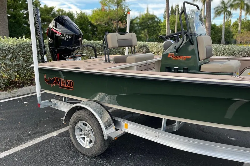Slide: The Image of 2026 Mako 18 Pro Skiff Backwater Edition boat on trailer, parked outdoors. - 3