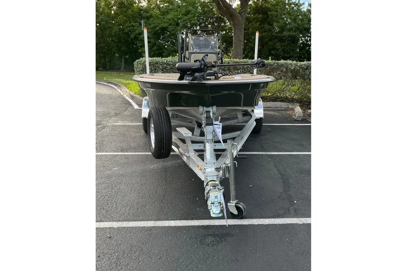 Slide: The Image of 2026 Mako 18 Pro Skiff Backwater Edition on trailer in parking lot. - 4