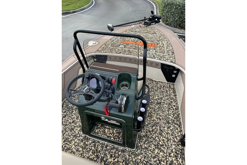 Slide: The Image of 2026 Mako 18 Pro Skiff Backwater Edition with camo deck and steering console. - 8