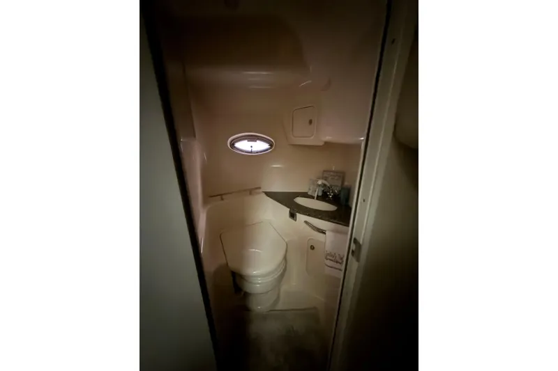 Slide: The Image of Bathroom interior of 2006 Sea Ray 44 Sundancer yacht with porthole and sink. - 13