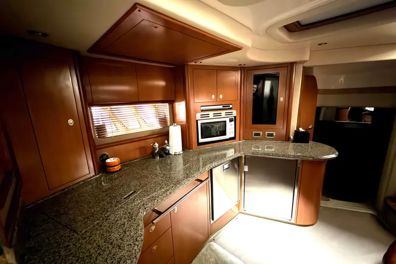 Slide: The Image of Luxurious 2006 Sea Ray 44 Sundancer yacht kitchen with sleek wood cabinetry and modern appliances. - 14