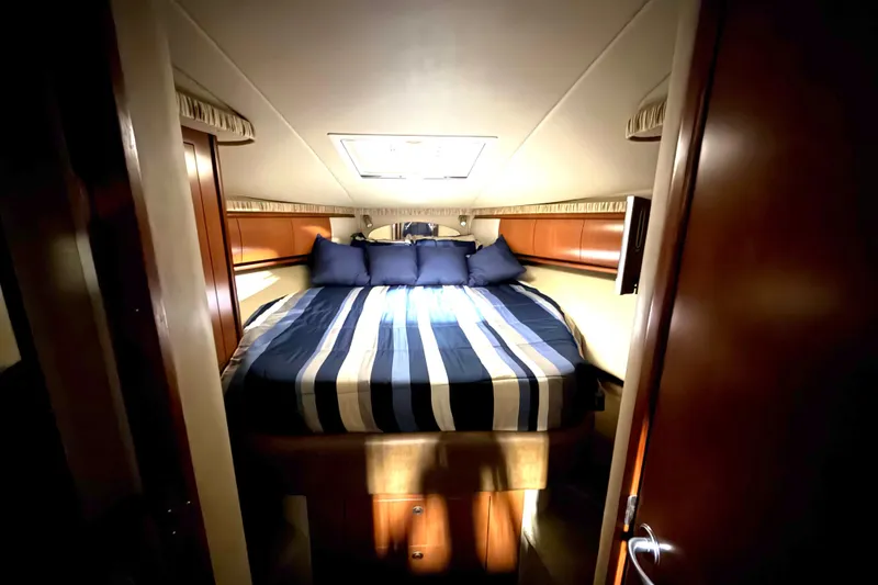 Slide: The Image of Luxurious cabin interior of 2006 Sea Ray 44 Sundancer yacht with striped bedding. - 15