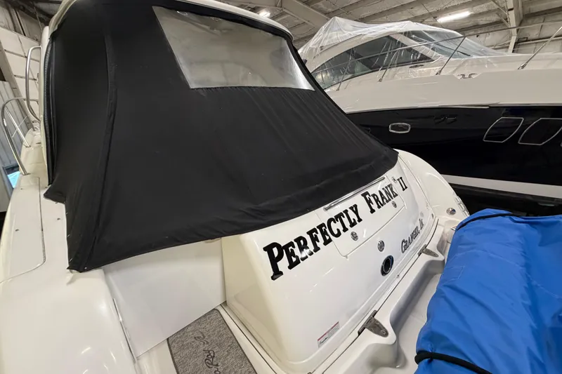 Slide: The Image of 2006 Sea Ray 44 Sundancer yacht with black cover, named "Perfectly Frank II." - 2