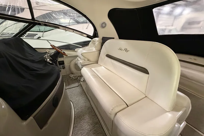 Slide: The Image of Interior of 2006 Sea Ray 44 Sundancer yacht with white seating and covered helm. - 4