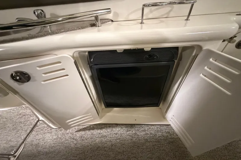 Slide: The Image of 2006 Sea Ray 44 Sundancer interior cabinet with open doors and built-in appliance. - 7