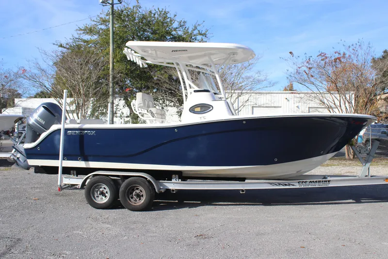 The Image of 2021 Sea Fox 249 Avenger boat on trailer, blue hull, parked outdoors. - 0