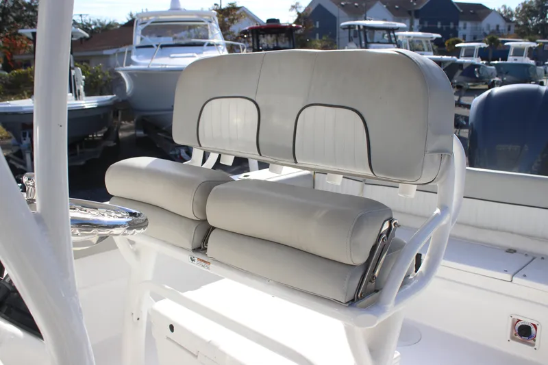 Slide: The Image of 2021 Sea Fox 249 Avenger boat seating with white cushioned bench and helm. - 5