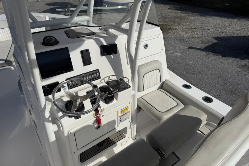 Slide: The Image of 2021 Sea Fox 249 Avenger boat cockpit with steering wheel and control panel. - 8