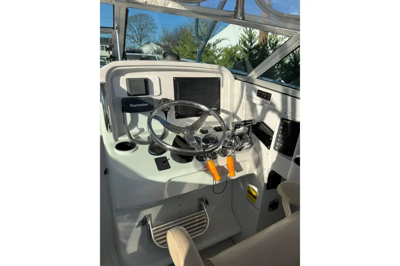 Slide: The Image of 2005 Glacier Bay 2670 Island Runner boat cockpit with steering wheel and navigation equipment. - 5