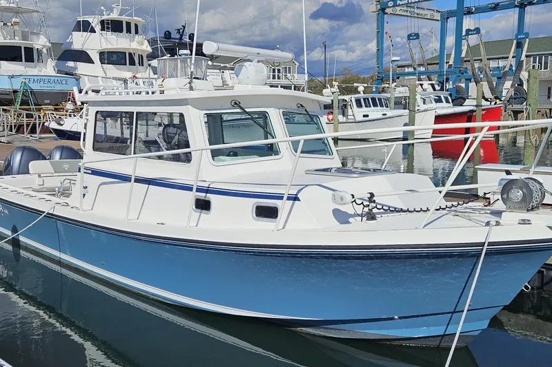 The Image of 2021 Steiger Craft 31 Miami boat docked at a marina, surrounded by other vessels. - 0