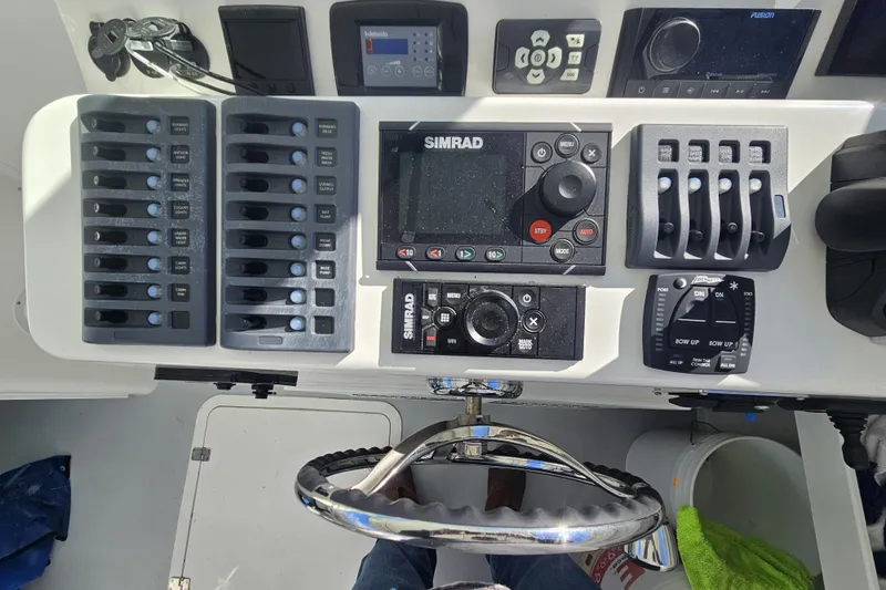 Slide: The Image of Steiger Craft 31 Miami 2021 dashboard with Simrad controls and switches. - 3