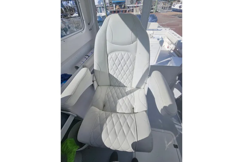 Slide: The Image of Captain's chair on 2021 Steiger Craft 31 Miami boat, featuring quilted upholstery. - 9