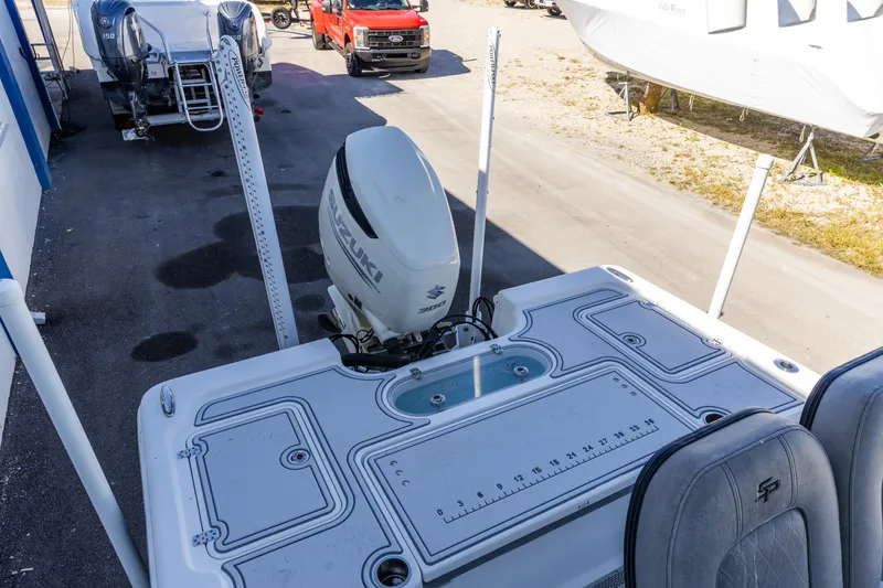 Slide: The Image of 2017 Sea Pro 248 Bay boat with Suzuki outboard motor, docked near a red truck. - 13