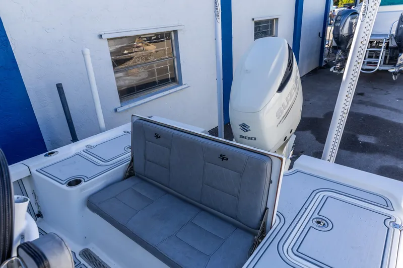 Slide: The Image of 2017 Sea Pro 248 Bay boat with Suzuki 300 engine, docked near a building. - 16