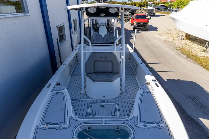 Slide: The Image of 2017 Sea Pro 248 Bay boat docked, featuring spacious deck and modern design. - 9