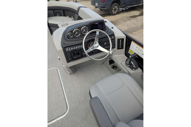 Slide: The Image of 2026 Berkshire 24RFX CTS boat dashboard with steering wheel and control panel. - 11