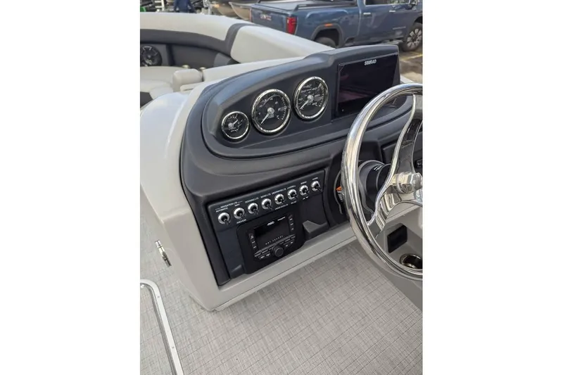 Slide: The Image of Dashboard of 2026 Berkshire 24RFX CTS boat with steering wheel and control panel. - 12