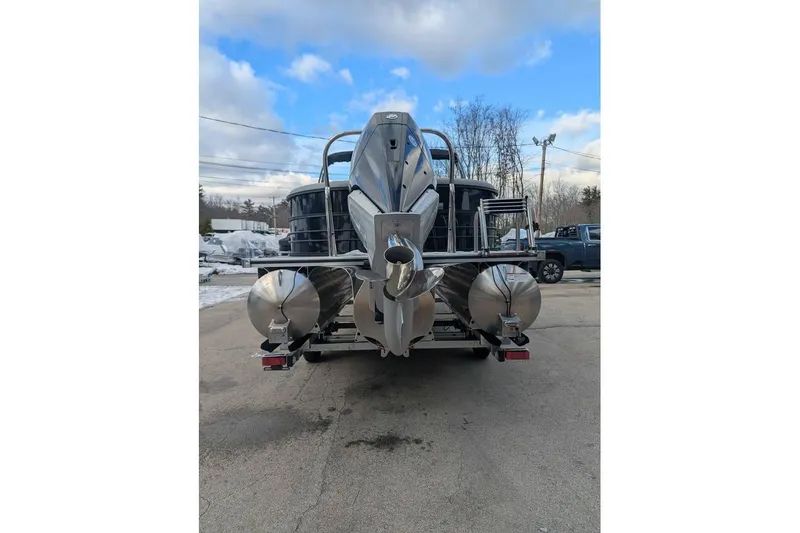 Slide: The Image of 2026 Berkshire 24RFX CTS pontoon boat, rear view, parked outdoors on a cloudy day. - 3