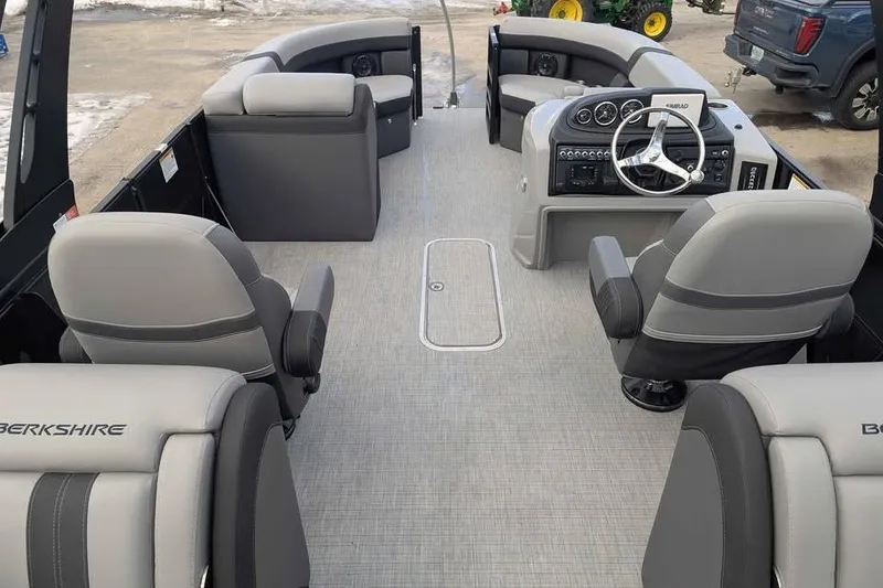 Slide: The Image of 2026 Berkshire 24RFX CTS pontoon boat interior with modern seating and steering console. - 7