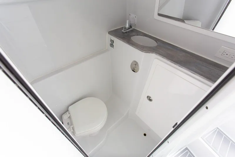 Slide: The Image of Compact bathroom in 2026 Contender 44 Fisharound boat with sink, toilet, and mirror. - 14