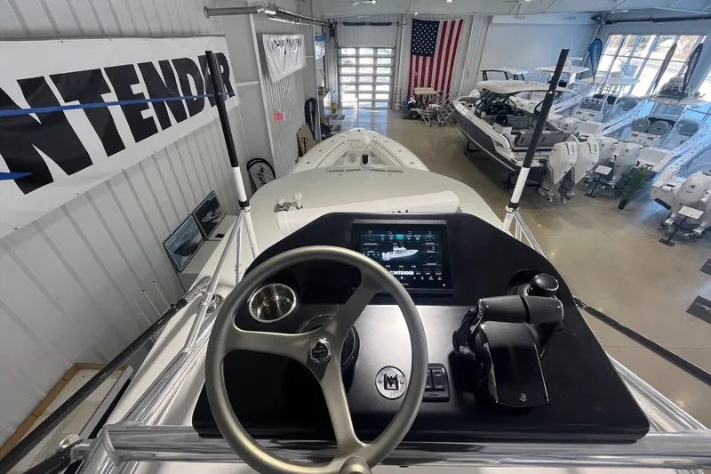 Slide: The Image of 2026 Contender 44 Fisharound boat interior with steering wheel and control panel in showroom. - 15
