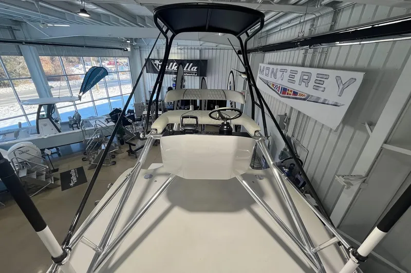 Slide: The Image of 2026 Contender 44 Fisharound boat interior with steering wheel, displayed in showroom. - 16