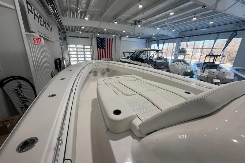 Slide: The Image of 2026 Contender 44 Fisharound boat interior with luxurious seating in a showroom. - 18