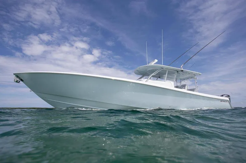 Slide: The Image of 2026 Contender 44 Fisharound with quad Mercury V10 outboard engines in showroom. - 2