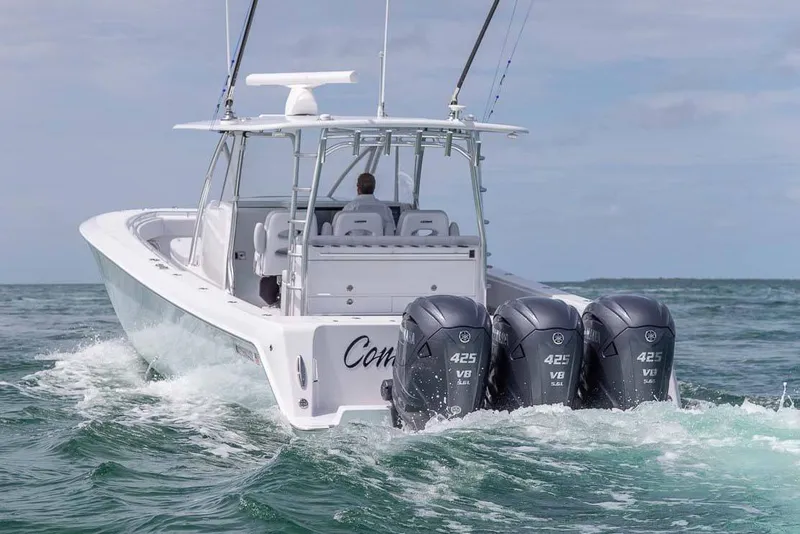 Slide: The Image of 2026 Contender 44 Fisharound with four Mercury Verado engines in showroom. - 4