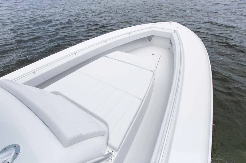 Slide: The Image of 2026 Contender 44 Fisharound boat interior with storage and seating in a showroom. - 6