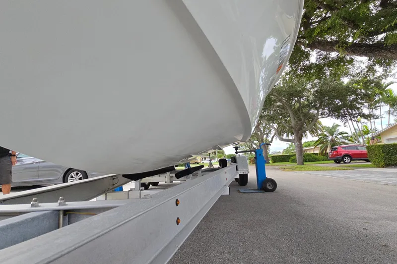 Slide: The Image of 2007 Yellowfin 24 Bay boat on trailer, parked in a residential area. - 17