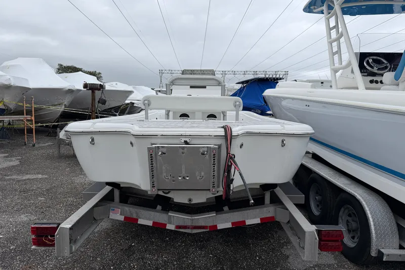 Slide: The Image of 2007 Yellowfin 24 Bay boat on trailer in storage yard, overcast sky. - 2