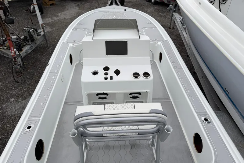 Slide: The Image of 2007 Yellowfin 24 Bay boat interior with console and seating, docked outdoors. - 3