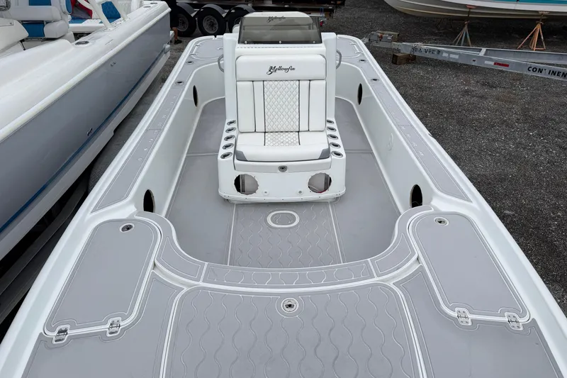 Slide: The Image of 2007 Yellowfin 24 Bay boat interior with white seating and gray deck. - 7