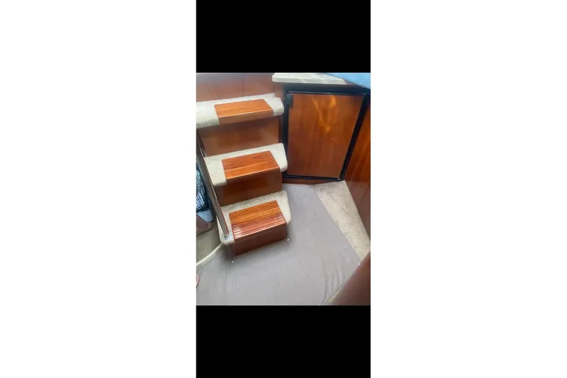 Slide: The Image of Interior stairs of 2006 Cruisers Yachts 340 Express with wooden steps. - 14