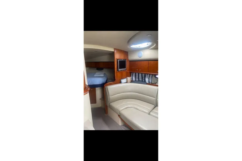 Slide: The Image of 2006 Cruisers Yachts 340 Express interior with leather seating and cozy cabin. - 16