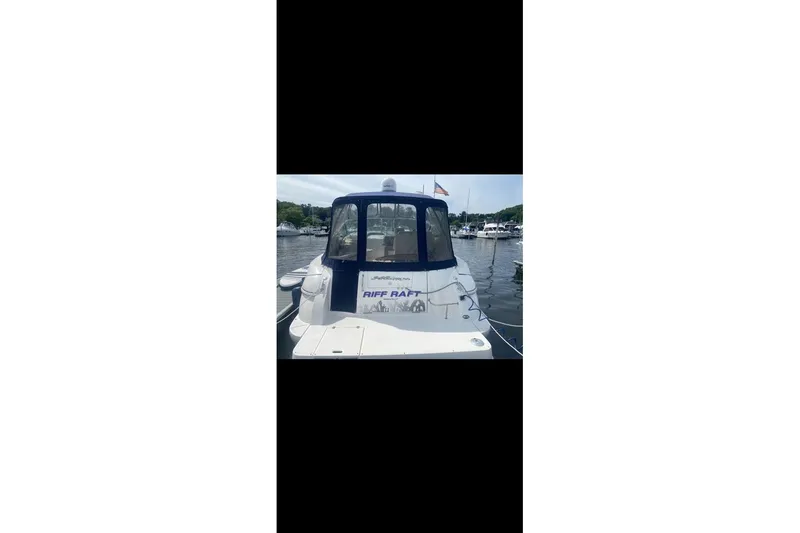 Slide: The Image of 2006 Cruisers Yachts 340 Express docked at a marina, rear view. - 3