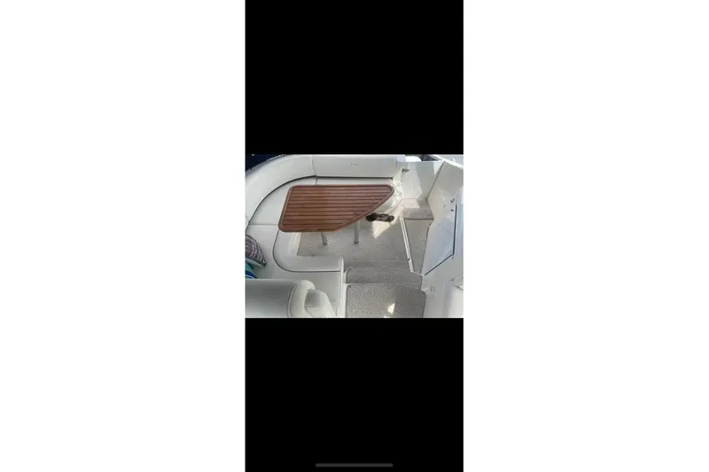 Slide: The Image of 2006 Cruisers Yachts 340 Express interior with wooden table and seating area. - 8