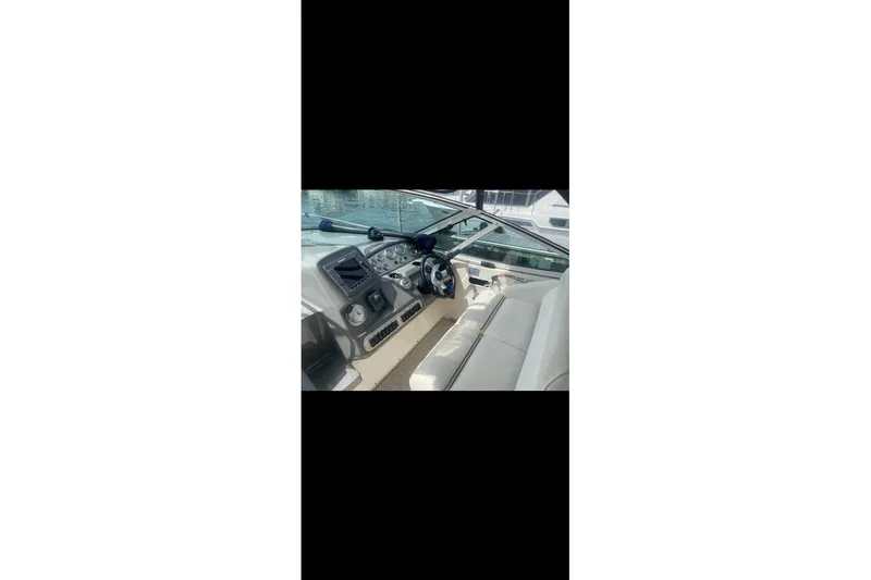 Slide: The Image of 2006 Cruisers Yachts 340 Express helm with steering wheel and control panel. - 9