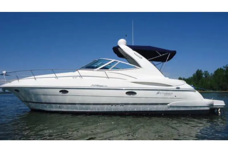 The Image of 2006 Cruisers Yachts 340 Express on water, side view, blue sky background. - 0